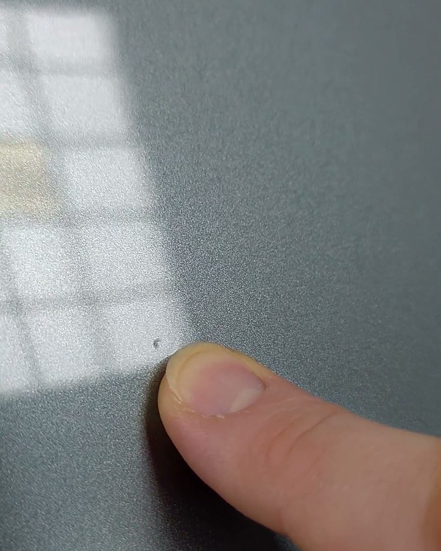 Texture and inclusions: dust nibs show up under a finger and a low light.