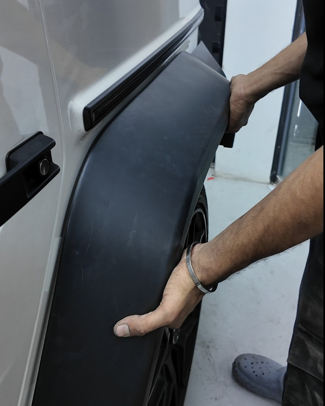 Wheel arch flare being fitted