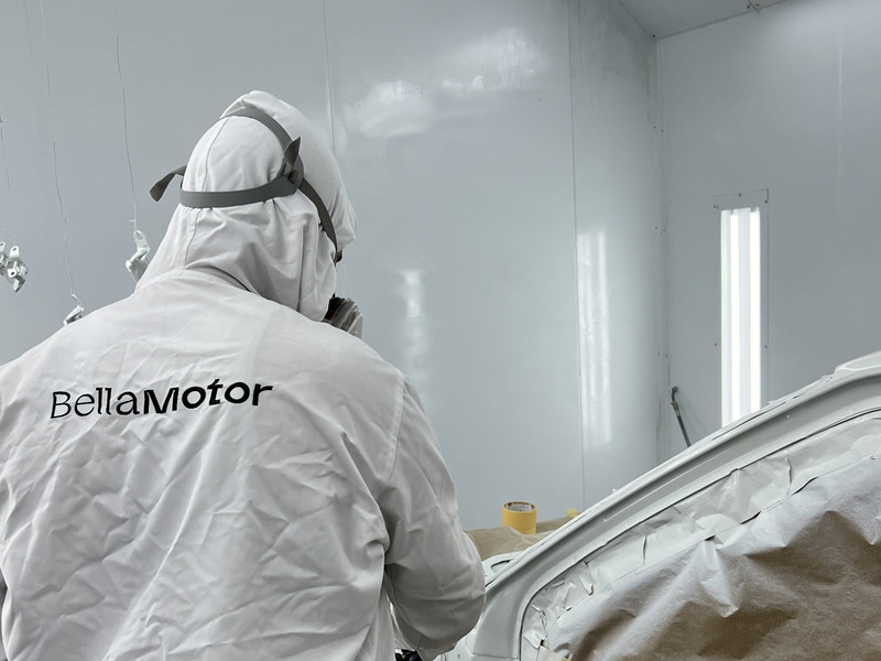 Painter spraying a car in the Bella Motor paint booth, Dubai