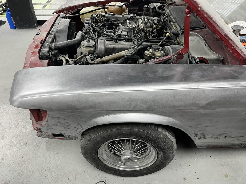Classic car wing stripped to bare metal for restoration