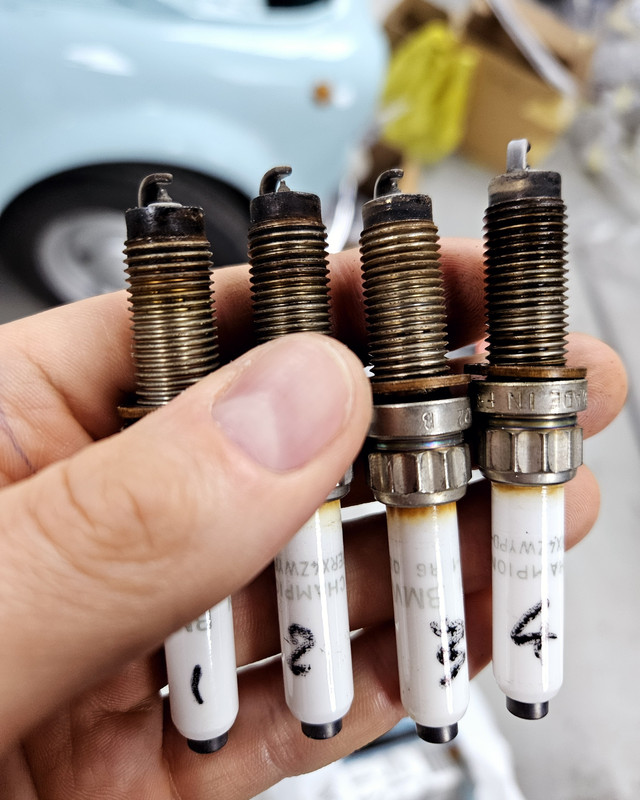 Worn spark plugs removed for replacement