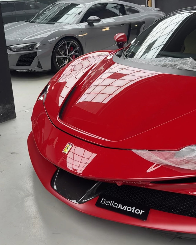 High-gloss red Ferrari and an Audi R8 in the Bella Motor workshop, Dubai