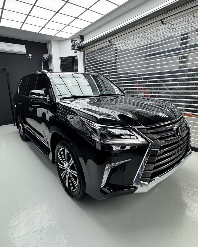 Gloss black Lexus LX in the showroom bay