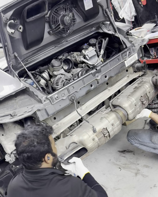 Rear engine bay opened with the exhaust removed for inspection