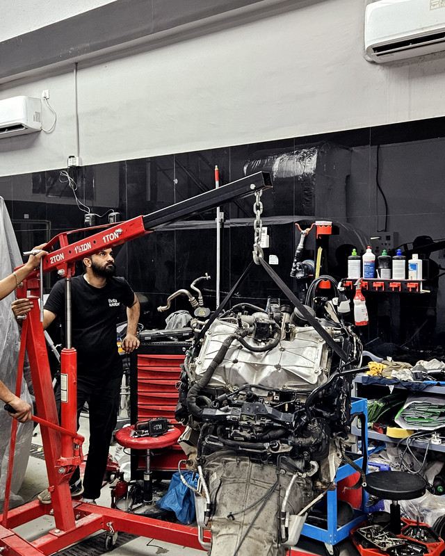 Engine and gearbox removed from the car on a hoist