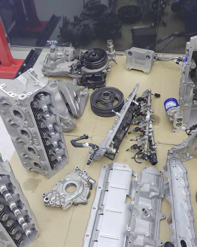 Engine components laid out on the bench during an overhaul