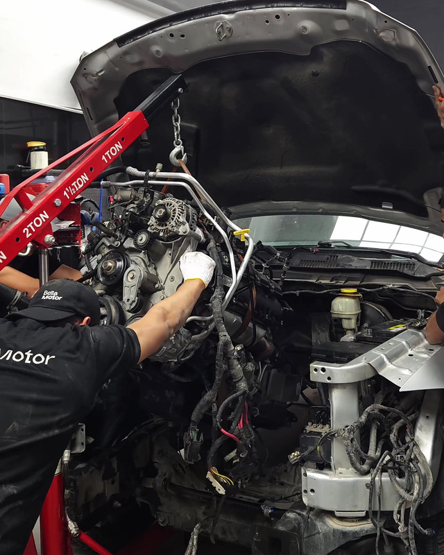 Engine being lifted out of the engine bay with a crane