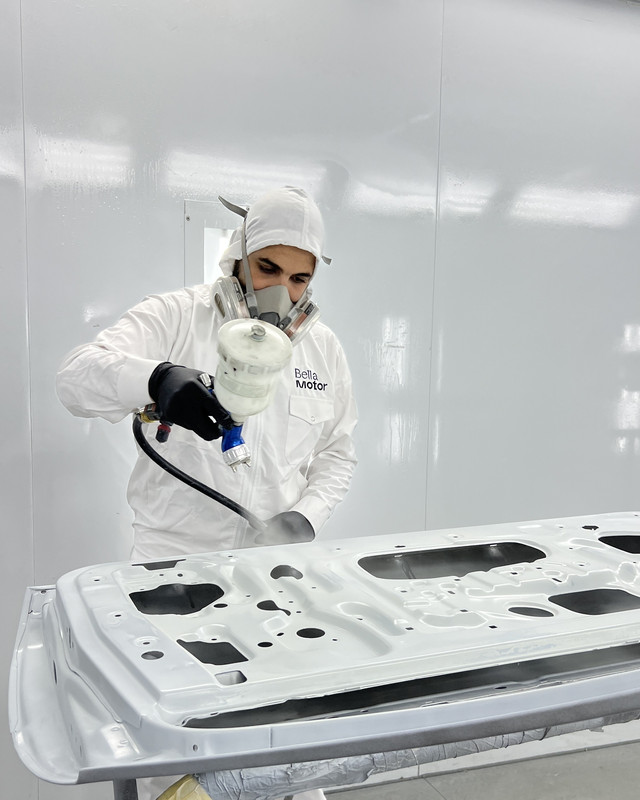 Painter applying an even coat to a door panel