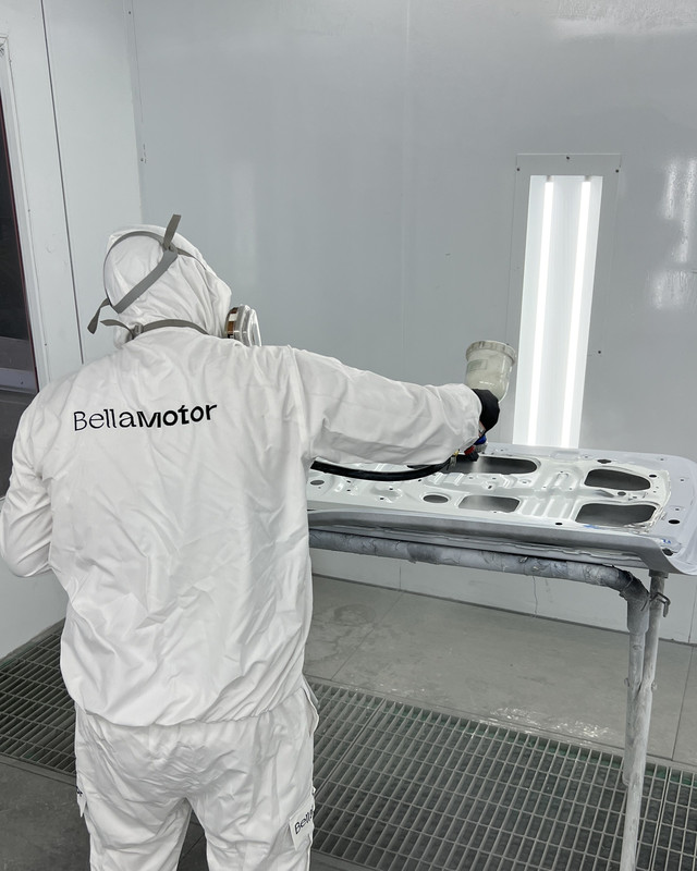 Bella Motor painter in the spray booth