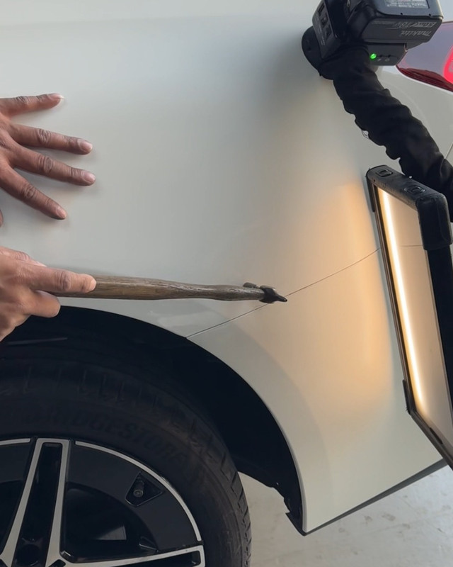 Dent removed with PDR tools on a white car