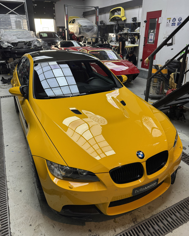 Yellow BMW M3 in the workshop