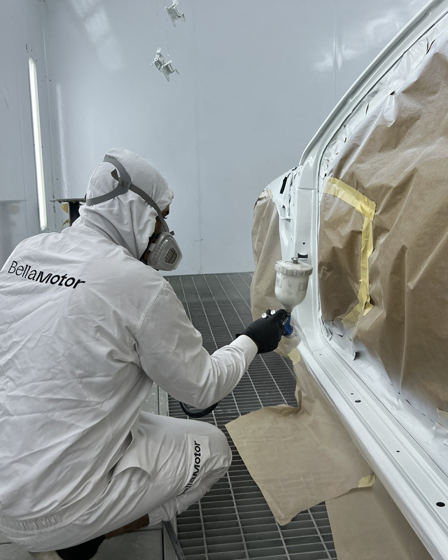Painter refinishing a door sill area