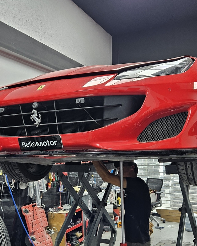 Sports car raised on the lift for chassis work